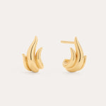 The Flame Stud Earrings in Gold, crafted with 18k gold plating and shaped like abstract flames, are shown against a neutral background—one earring displays the front view, while the other reveals the sculptural side and post.