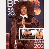 Fleur East poses on the red carpet in a brown satin outfit with dramatic sleeves and a white collar, accessorized with the Nola Pavé Triple Band Ring in Silver, a brown clutch bag, and manicured nails at the 2023 BRIT Awards.