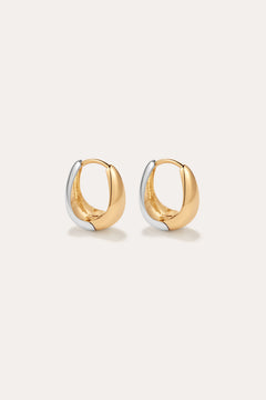 The Gia Reversible 2 Tone Chubby Hoop Earrings feature a smooth, rounded design in 18k gold and sterling silver, shown against a plain light background.