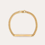 The Gisèle Cuban Link Bar Bracelet in Gold features a gold-plated chain, a lobster clasp, and a horizontal rectangular bar embellished with small sparkling clear stones.