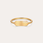 The Ines Horizontal Bar Ring in Gold features a flat, elongated plate adorned with a cluster of small sparkling diamonds on one side, shown against a plain white background.