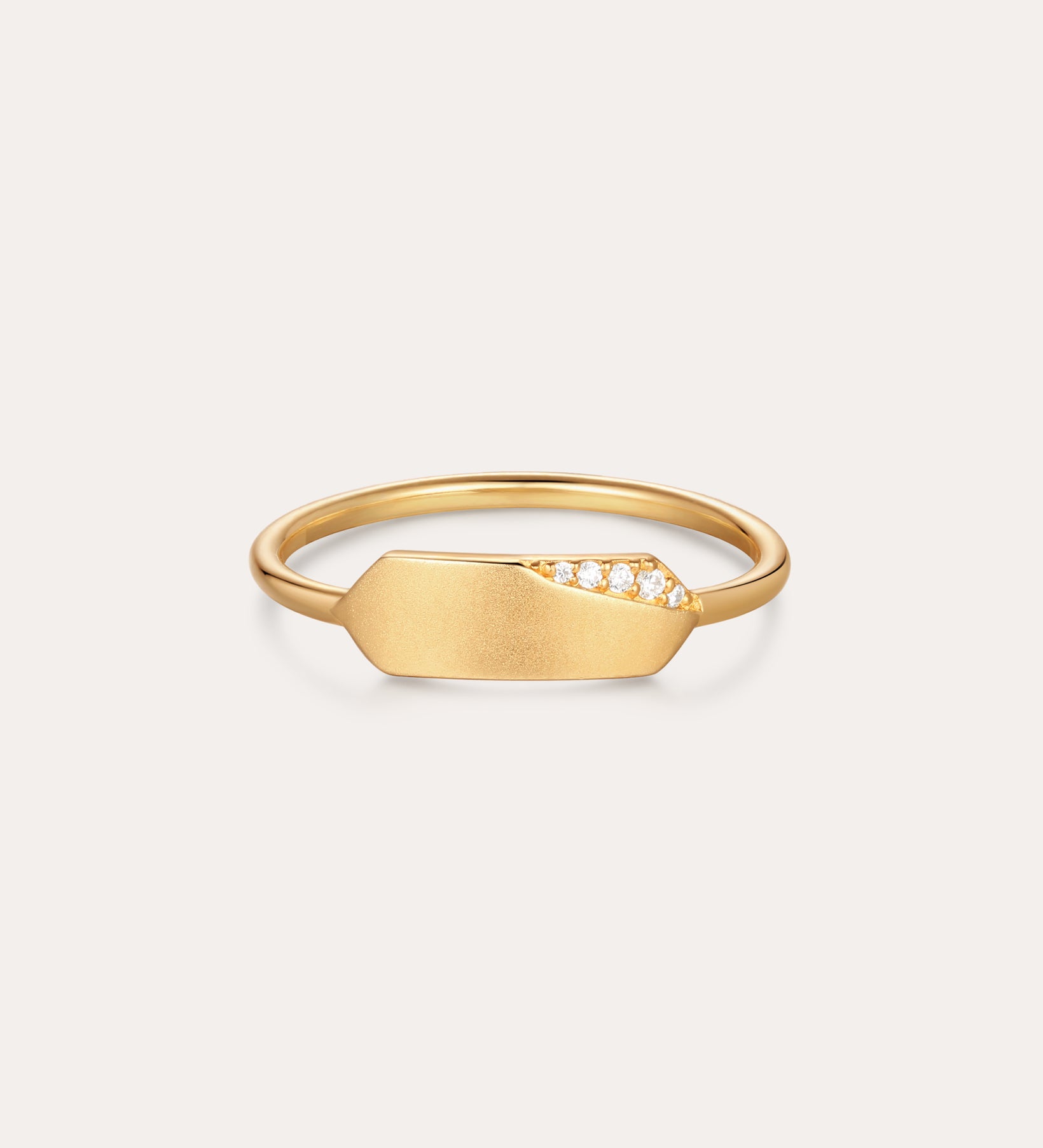 The Ines Horizontal Bar Ring in Gold features a flat, elongated plate adorned with a cluster of small sparkling diamonds on one side, shown against a plain white background.