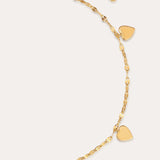 The Louise Gold Heart Anklet features four small gold hearts and a central heart with clear stones on a delicate gold chain. With an adjustable clasp, it can also be worn as a bracelet. Displayed on a plain light background.