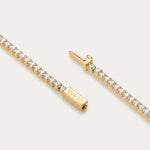 A close-up of the Lumi Tennis Bracelet in Gold shows small round white stones and a rectangular clasp engraved with VANCLI.
