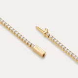 A close-up of the Lumi Tennis Bracelet in Gold shows small round white stones and a rectangular clasp engraved with VANCLI.