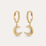 Crescent Moon Crystal Charm Huggies in Gold, featuring crescent moon charms with sparkling cubic zirconia, displayed on a plain light background.