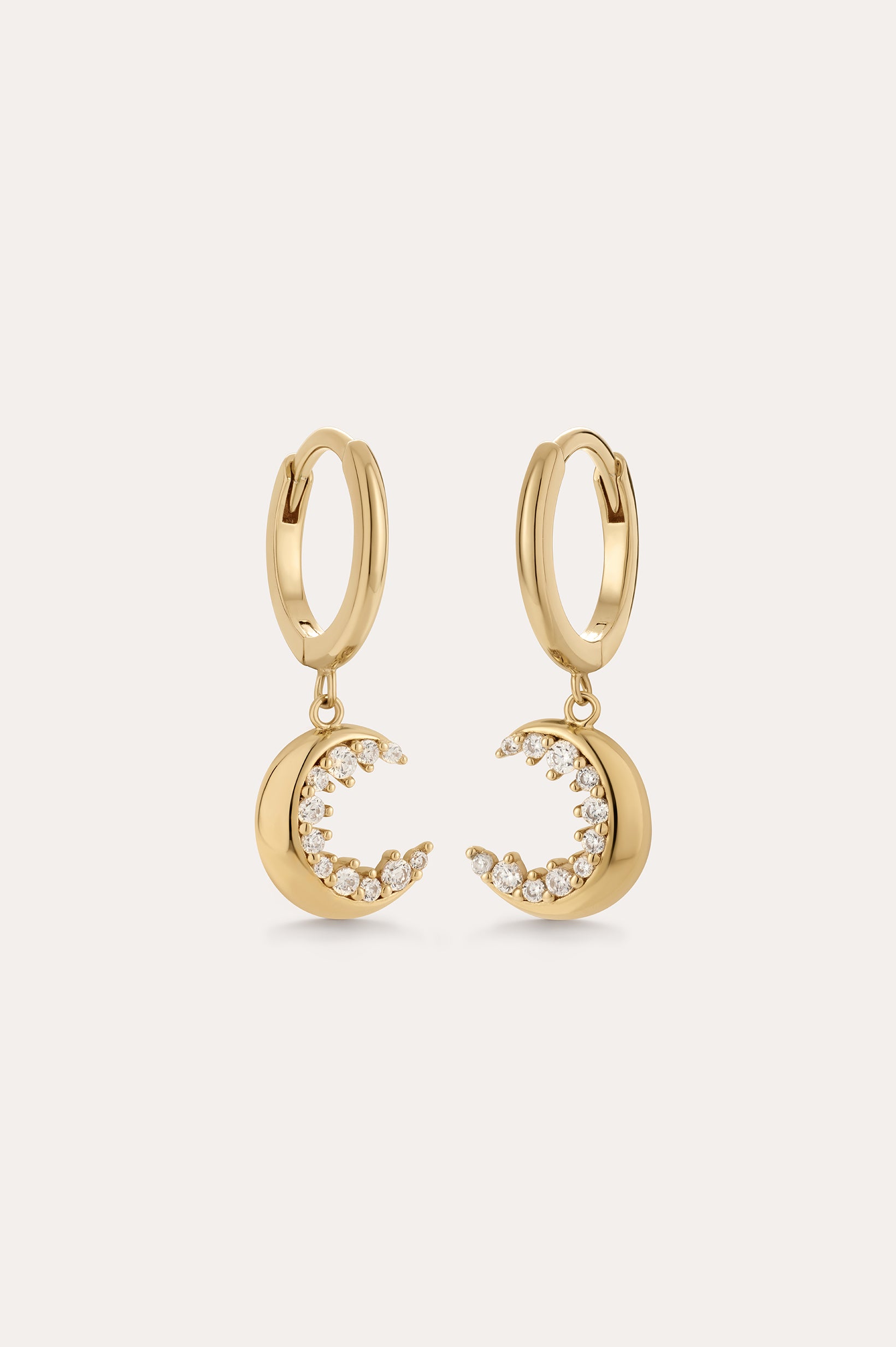 Crescent Moon Crystal Charm Huggies in Gold, featuring crescent moon charms with sparkling cubic zirconia, displayed on a plain light background.