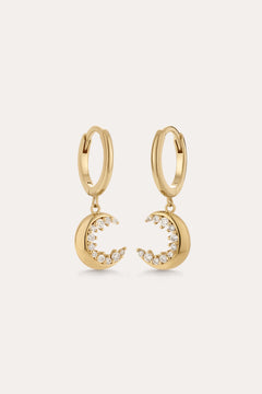 Crescent Moon Crystal Charm Huggies in Gold, featuring crescent moon charms with sparkling cubic zirconia, displayed on a plain light background.