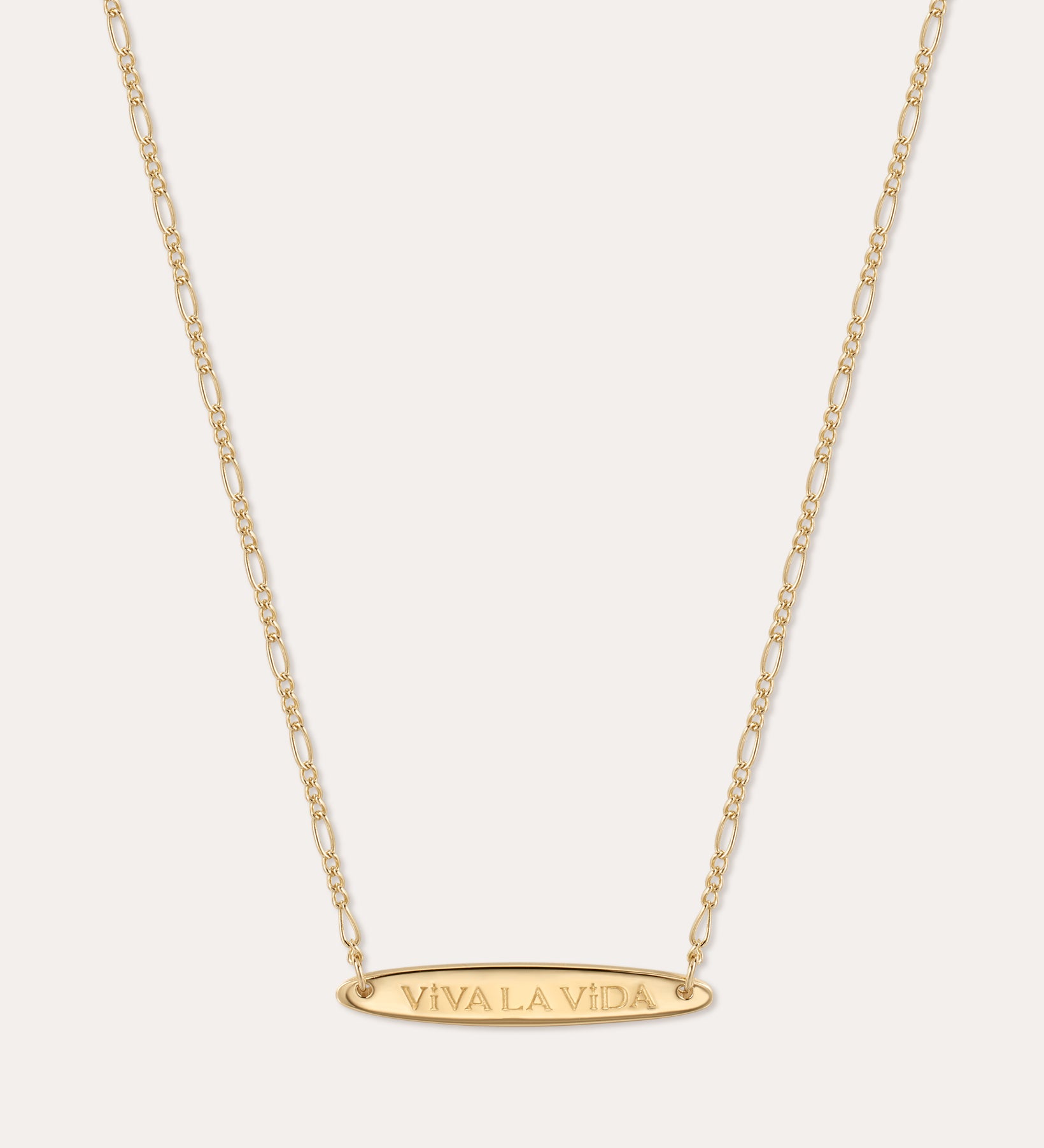 The Viva La Vida Bar Chain Necklace in Gold features an oval horizontal pendant engraved with VIVA LA VIDA on an adjustable delicate figaro chain for the perfect fit.
