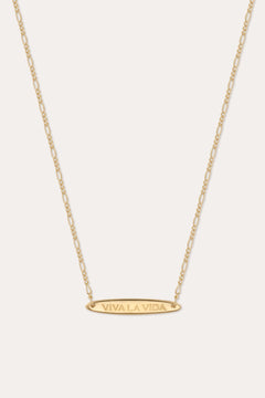 The Viva La Vida Bar Chain Necklace in Gold features an oval horizontal pendant engraved with VIVA LA VIDA on an adjustable delicate figaro chain for the perfect fit.