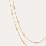 The Simona Double Chain Stacking Necklace in Gold features delicate oval-shaped accents spaced evenly along its length, ideal for stacking or layering, and is shown against a simple, light background.