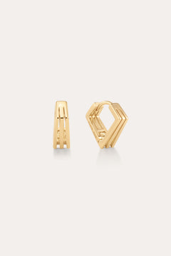 The Juliet Angular Huggies in Gold, featuring a modern geometric design with parallel lines and angular edges, are displayed on a light neutral background—perfect for fans of stylish gold huggies.