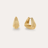 The Juno Ridged Chunky Hoops in Gold feature a modern, shell-inspired design. Displayed on a light background, one hoop stands upright while the other is open to showcase the clasp.