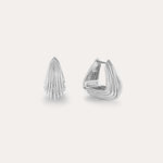 The Juno Ridged Chunky Hoops in Silver, featuring a modern fan-like ridged pattern, are showcased against a plain light background, with one earring closed and the other open to highlight the clasp design.