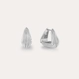 The Juno Ridged Chunky Hoops in Silver, featuring a modern fan-like ridged pattern, are showcased against a plain light background, with one earring closed and the other open to highlight the clasp design.