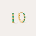 The Kiki Crystal Huggie Earrings in 18k Gold Plated/Green feature a row of green crystals on each earring, with one shown from the side and one from the front—versatile, stylish options for daily wear.