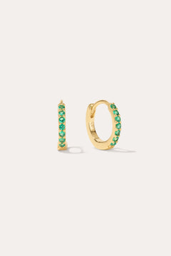 The Kiki Crystal Huggie Earrings in 18k Gold Plated/Green feature a row of green crystals on each earring, with one shown from the side and one from the front—versatile, stylish options for daily wear.