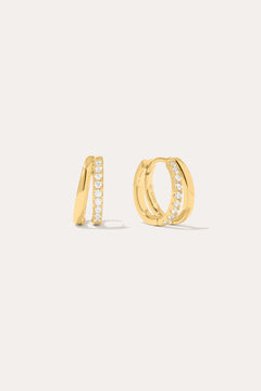 Kira Crystal Double Hoop Huggies in 18k Gold Plated, featuring a row of clear round crystals along the front, are displayed against a plain off-white background.