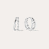 The Kira Crystal Double Hoop Huggies in Sterling Silver are shown, each featuring a row of sparkling round crystals along the front edge. The background is plain and light-colored.