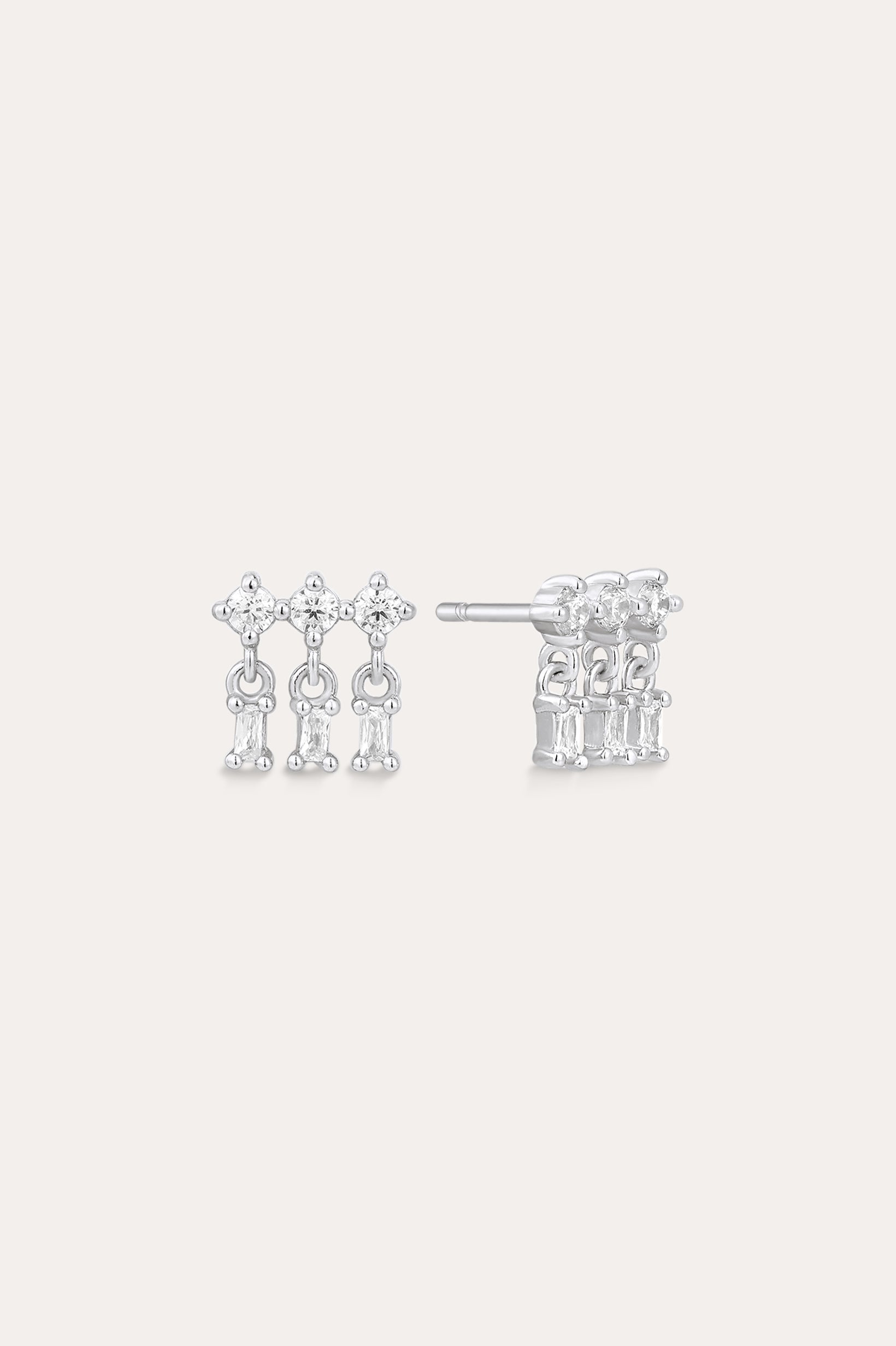 The Lexi Crystal Studs Earrings in Silver showcase three vertical rows of sparkling cubic zirconia in a geometric design, displayed on a neutral background.