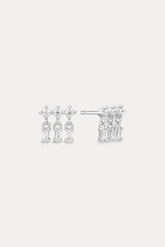 The Lexi Crystal Studs Earrings in Silver showcase three vertical rows of sparkling cubic zirconia in a geometric design, displayed on a neutral background.