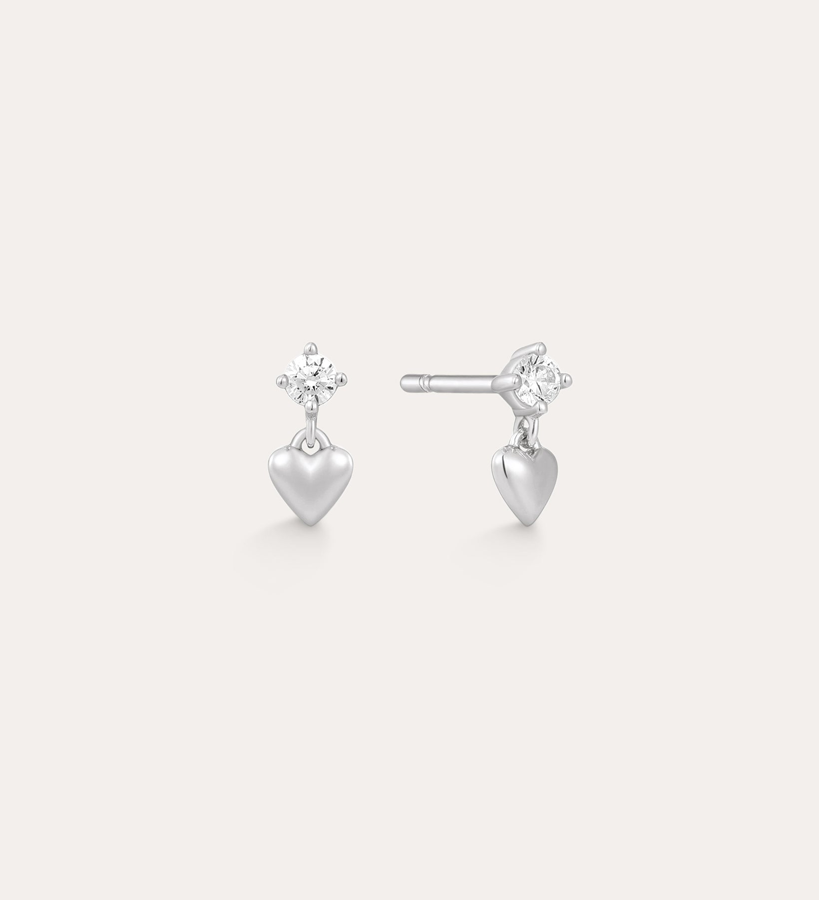 The Lilian Crystal Heart Studs Earrings in Silver feature a sparkling star-shaped gemstone above a dangling silver heart charm—perfect dainty earrings for any occasion.