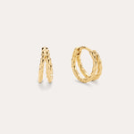 The Mae Twist Double Huggie Earrings in Gold, featuring a delicate twisted rope design, are displayed against a plain, light background.