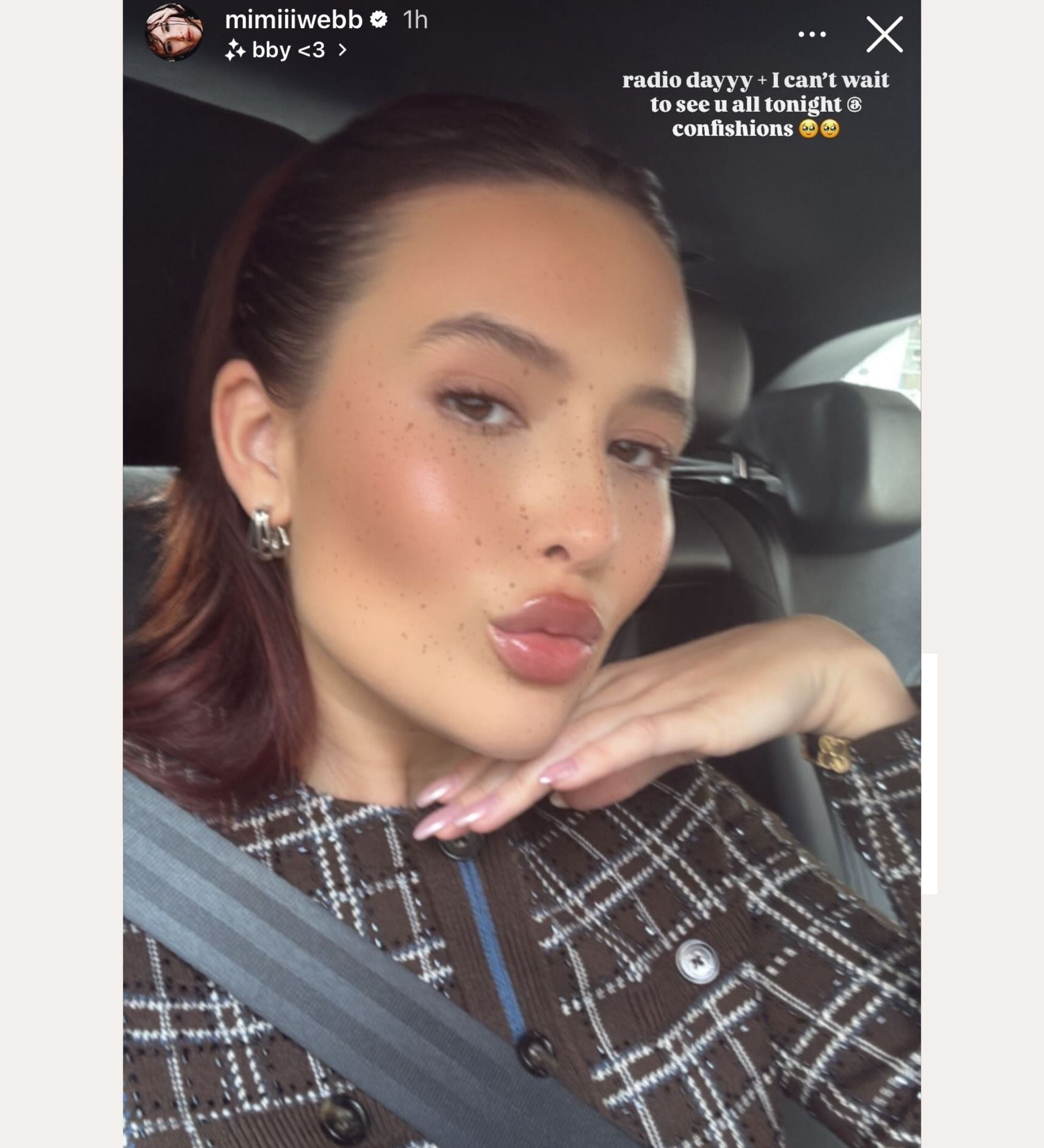 A young woman with slicked-back brown hair takes a car selfie, wearing a plaid top and Esther Square Hoop Stud Earrings in Silver. Text above her reads, “radio dayyy ·· I can’t wait to see y’all tonight @ confessions.”.