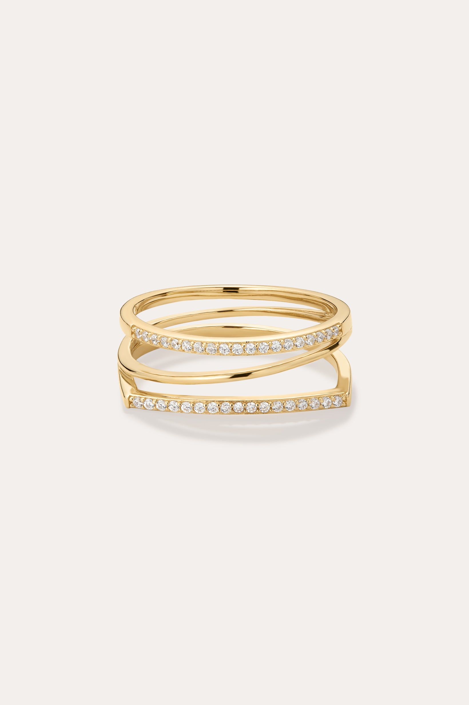 The Nola Pavé Triple Band Ring in Gold features a modern, stacked design with three gold bands, each pavé-set with sparkling diamonds, displayed against a plain light background.