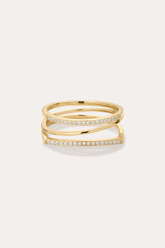 The Nola Pavé Triple Band Ring in Gold features a modern, stacked design with three gold bands, each pavé-set with sparkling diamonds, displayed against a plain light background.