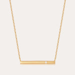 The Regina Horizontal Bar Pendant Necklace in Gold features a minimalist horizontal bar with an off-center cubic zirconia, making it perfect for lovers of simple, elegant jewelry.