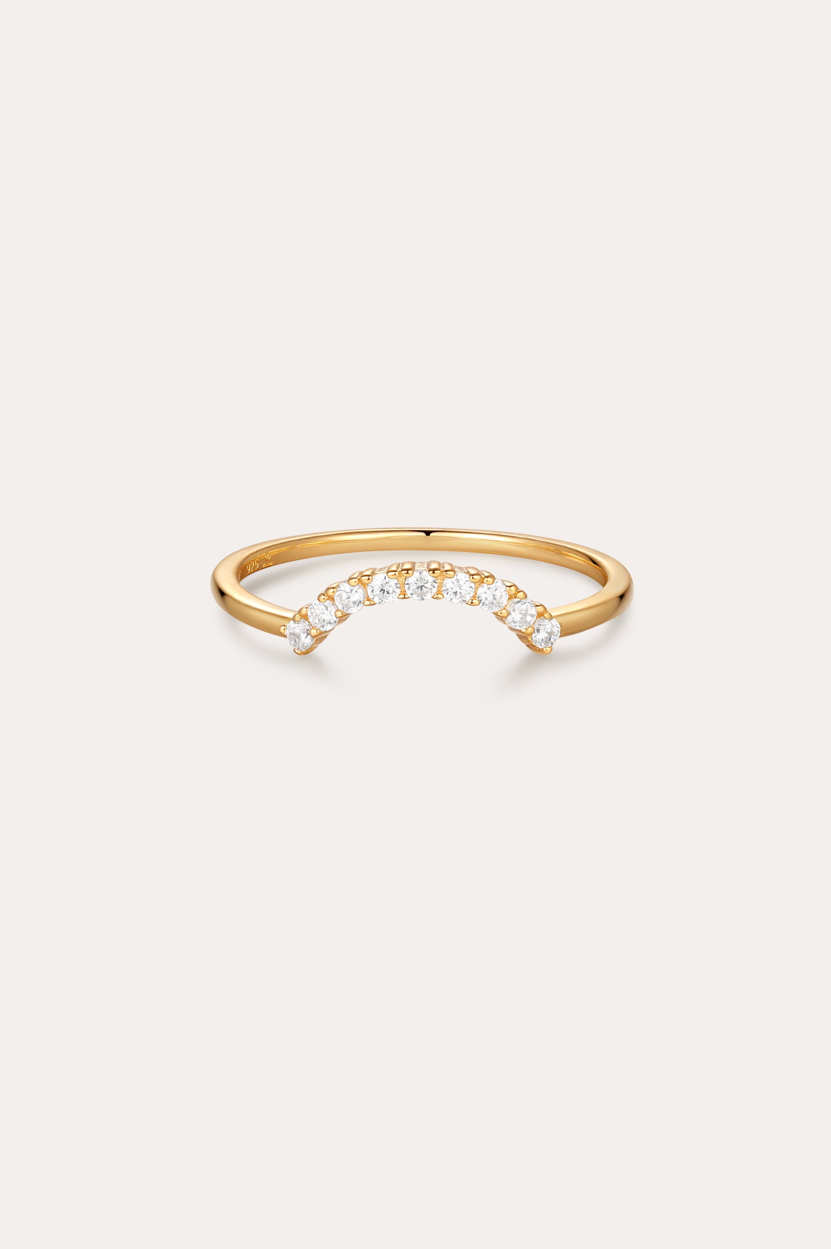 The Reine Rainbow Crystal Ring in Gold features a curved row of small, round crystals set along the top, shown on a simple light background.