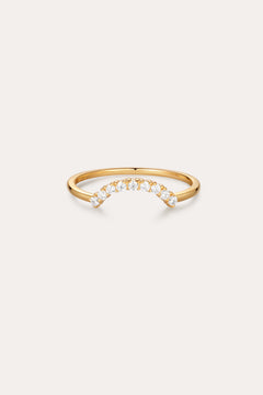 The Reine Rainbow Crystal Ring in Gold features a curved row of small, round crystals set along the top, shown on a simple light background.