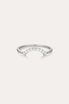 The Reine Rainbow Crystal Ring in Silver is a delicate sterling silver ring with a gentle curve, featuring a row of small, sparkling rainbow crystals set along the curved band. Its thin, minimalist design adds elegant color to any look.