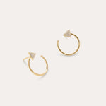 The Reneé Triangle Linear Hoop Stud Earrings in Gold feature a bold triangle design adorned with clear stones, making them the perfect choice for fans of unique gold earrings. Displayed on a simple light background.