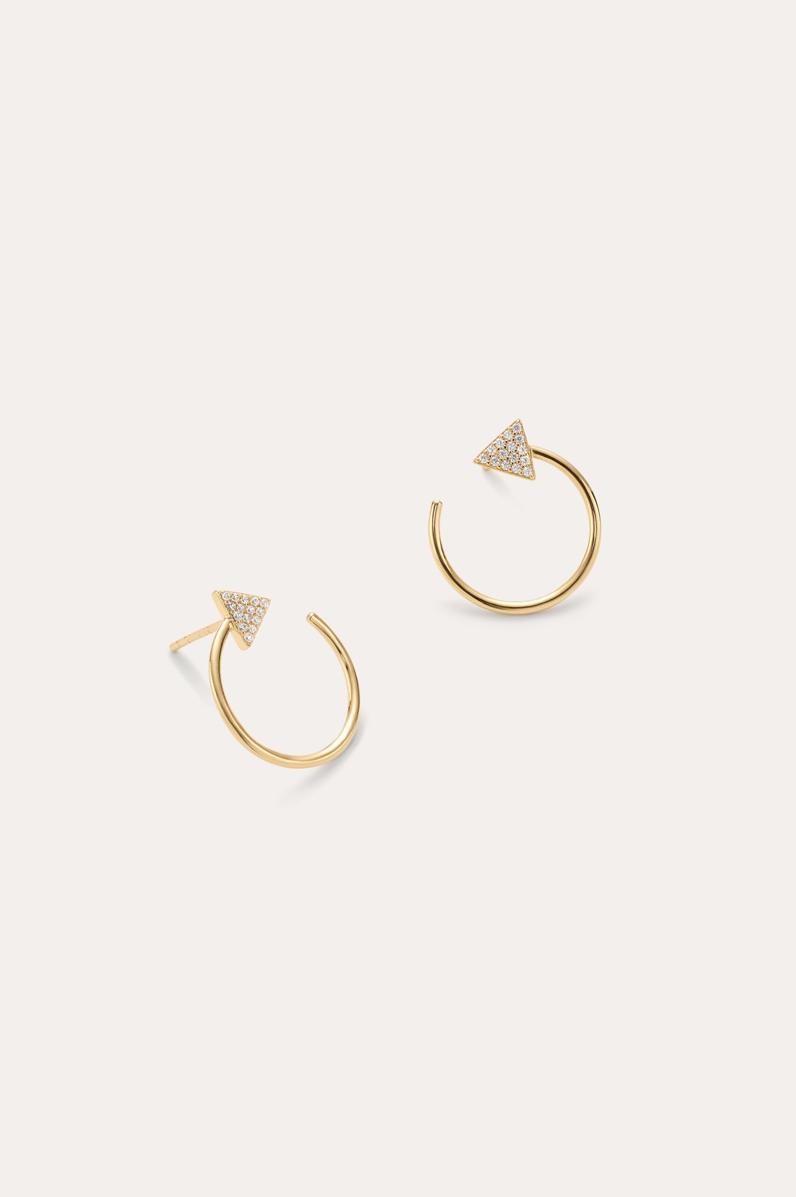The Reneé Triangle Linear Hoop Stud Earrings in Gold feature a bold triangle design adorned with clear stones, making them the perfect choice for fans of unique gold earrings. Displayed on a simple light background.