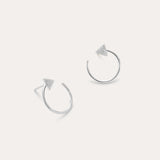 Reneé Triangle Linear Hoop Stud Earrings in Silver feature small textured triangles at the ends of sleek hoops, shown on a plain light background.
