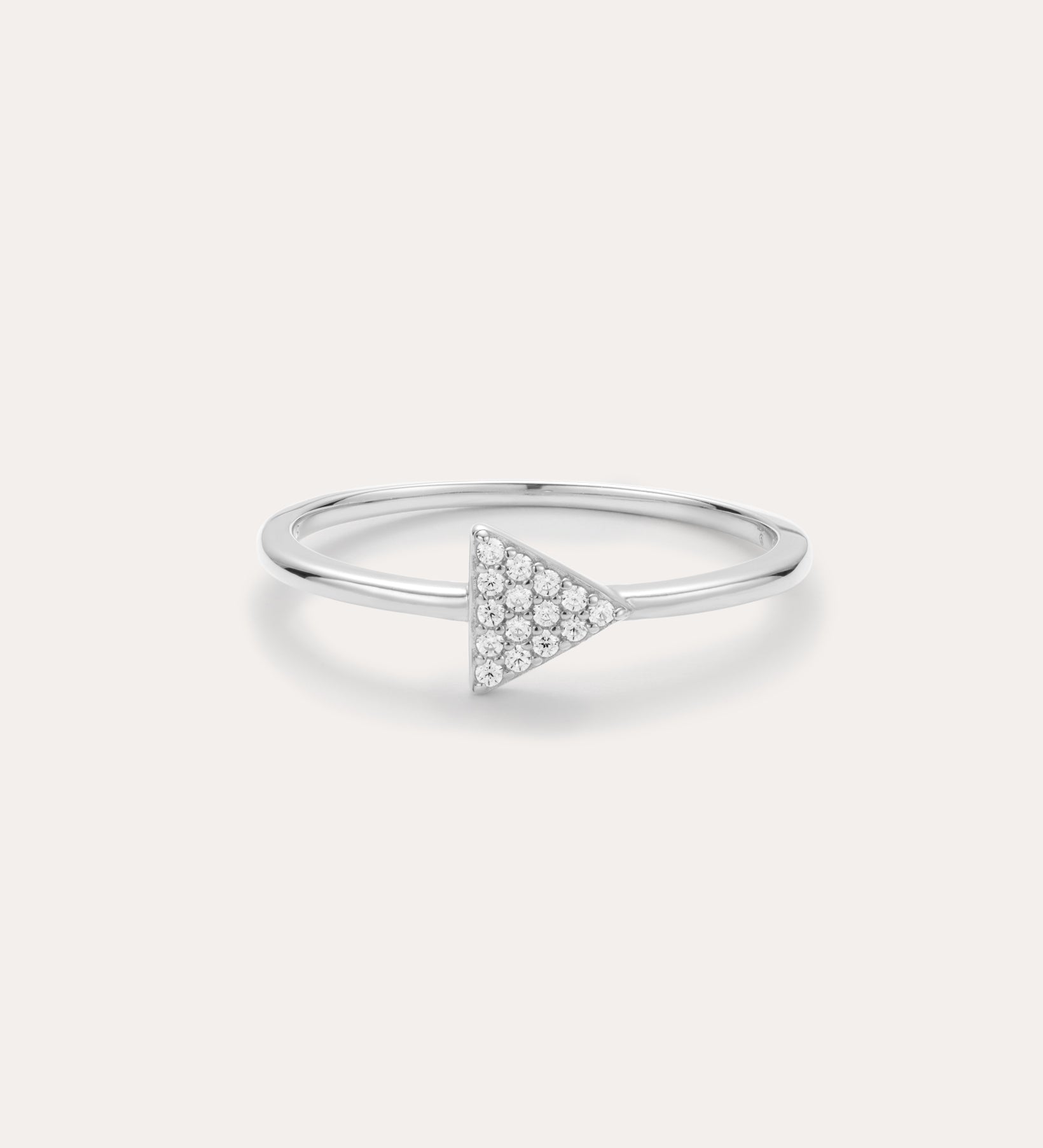 Silver ring with a triangle-shaped gemstone on a light gray background