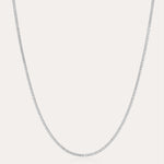 The Alba Tennis Necklace in Silver is displayed against a plain white background, highlighting its delicate and understated elegance.