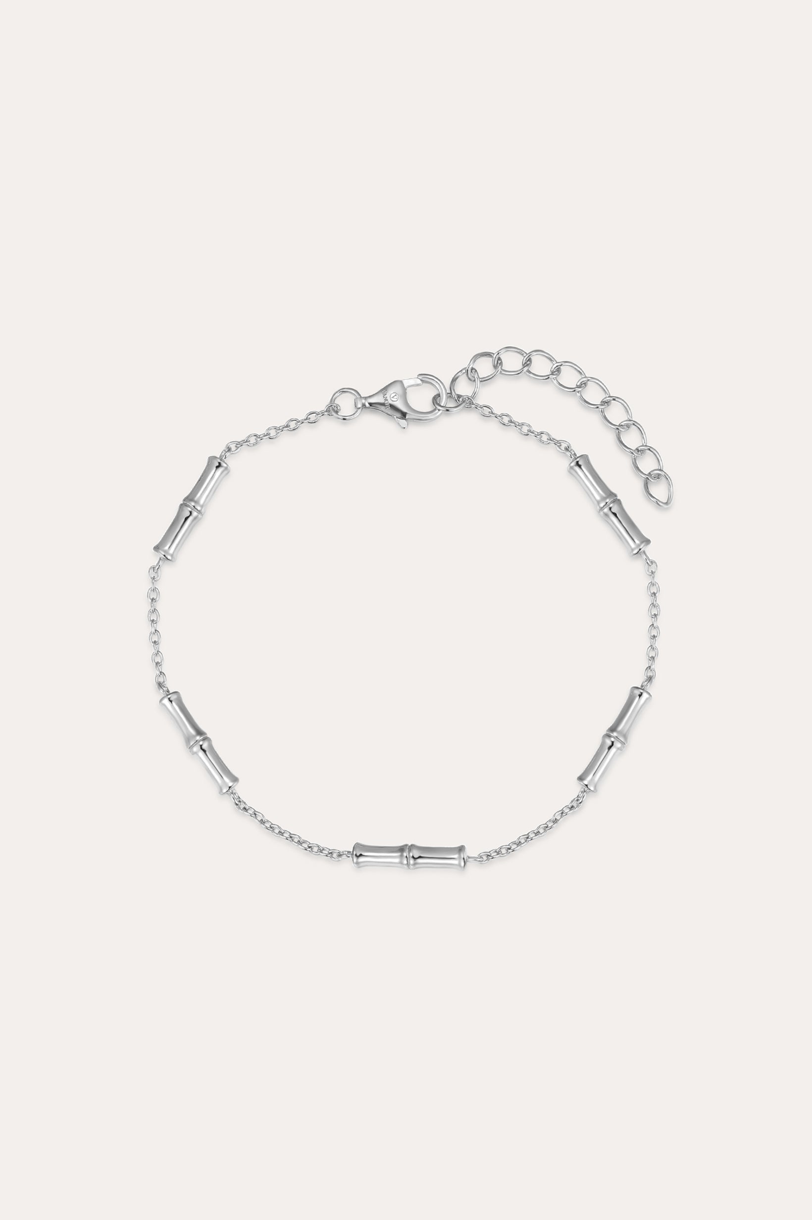 The Bamboo Chain Bracelet in Silver features small, evenly spaced cylindrical accents on a fine S925 sterling silver chain with a lobster clasp and adjustable extension. Displayed against a plain, light background.