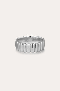 The Charlotte Eternity Ridged Ring in Silver features a rounded, ribbed design around its band and is showcased on a plain light background.