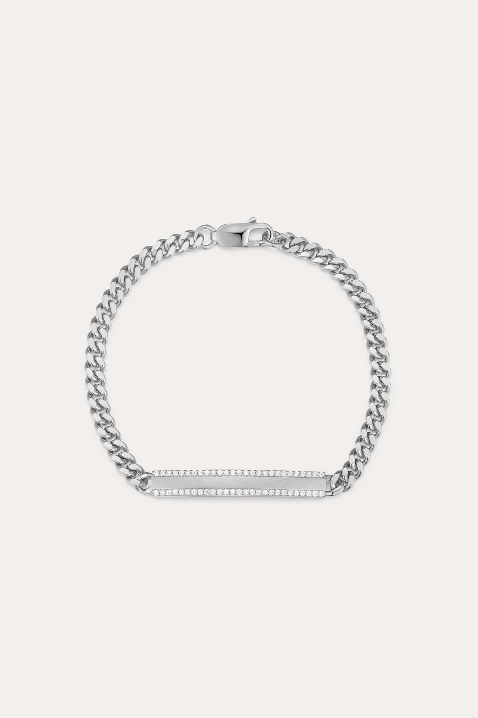 The Gisèle Cuban Link Bar Bracelet in Silver features a sterling silver Cuban link design, a rectangular bar adorned with sparkling cubic zirconia stones, and is finished with a secure lobster clasp.