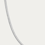 The Estelle Herringbone Chain Necklace in Silver is showcased on a plain white background, emphasizing its elegant and timeless style.