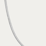 The Estelle Herringbone Chain Necklace in Silver is showcased on a plain white background, emphasizing its elegant and timeless style.