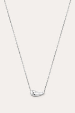Silver necklace with a curved pendant on a light gray background