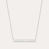 The Regina Horizontal Bar Pendant Necklace in Silver features a minimalist silver bar with a single, sparkling cubic zirconia at its center—ideal for lovers of simple, elegant jewelry.