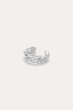 The Vera Twisted Crystal Ear Cuff in Silver is an adjustable sterling silver (stamped 925) ring with a twisted design and embedded clear gemstones, displayed on a plain light background.