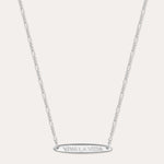 The Viva La Vida Bar Chain Necklace in Silver features a delicate, adjustable Figaro chain and an engraved oval horizontal bar pendant with VIVA LA VIDA in capitals, shown on a plain white background.