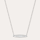 The Viva La Vida Bar Chain Necklace in Silver features a delicate, adjustable Figaro chain and an engraved oval horizontal bar pendant with VIVA LA VIDA in capitals, shown on a plain white background.