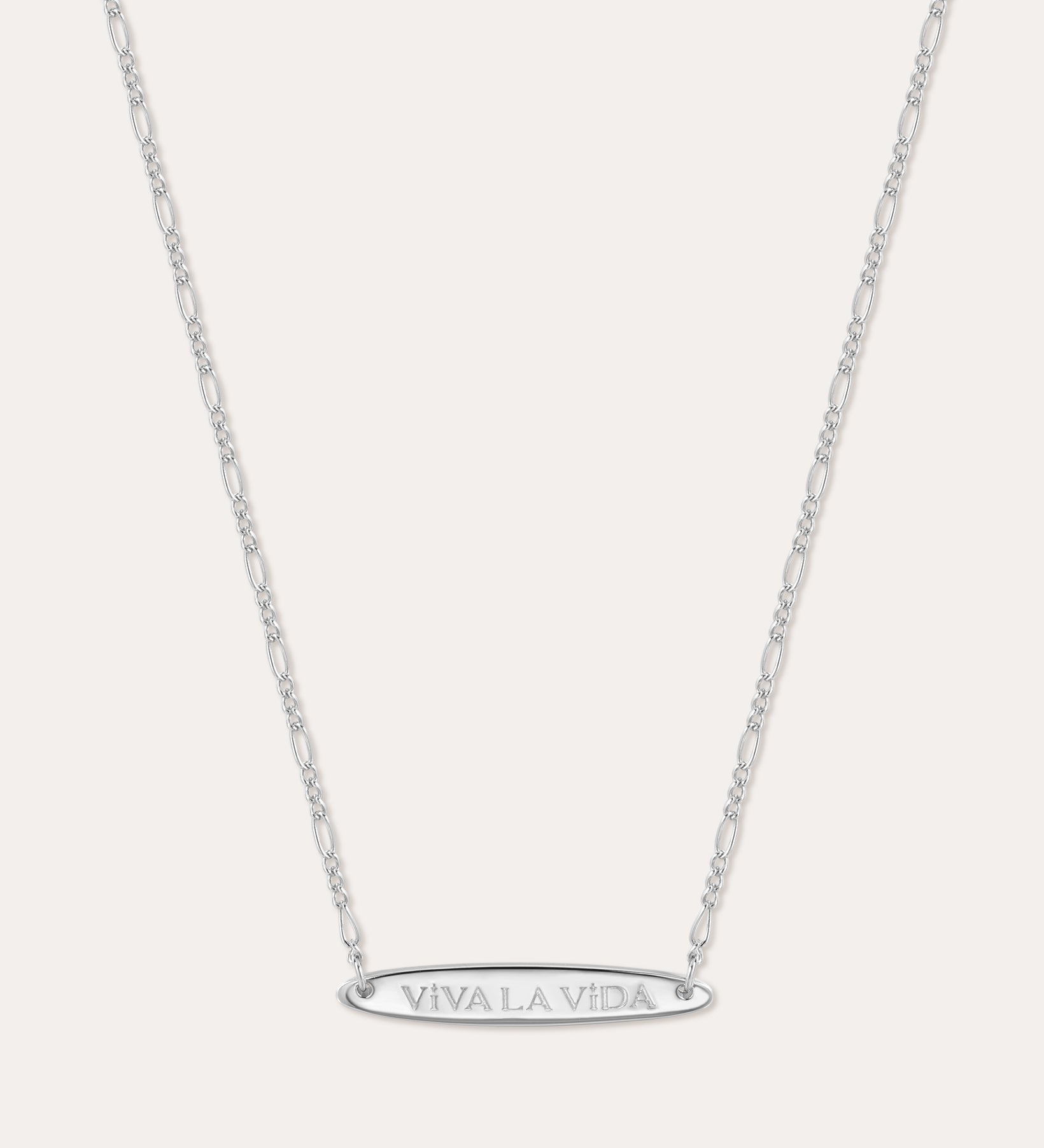 The Viva La Vida Bar Chain Necklace in Silver features a delicate, adjustable Figaro chain and an engraved oval horizontal bar pendant with VIVA LA VIDA in capitals, shown on a plain white background.